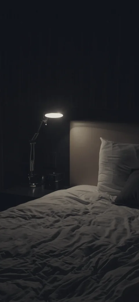 The same dark bedroom, closer in.